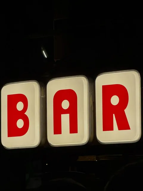 A BAR sign at night